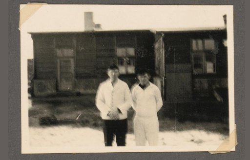 Ob. Gfr. Drössiger and a soldier in front of buildings