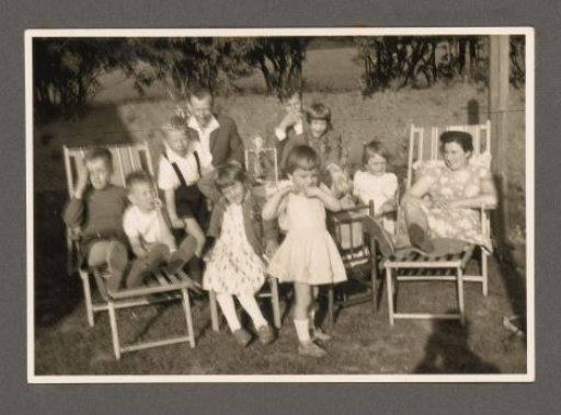 Man and woman with children in a garden