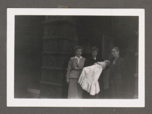 Three women with a baby at a baptism