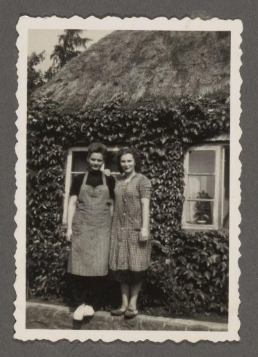 Two Women in Front of a House