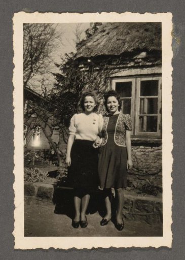Two Women in Front of a House