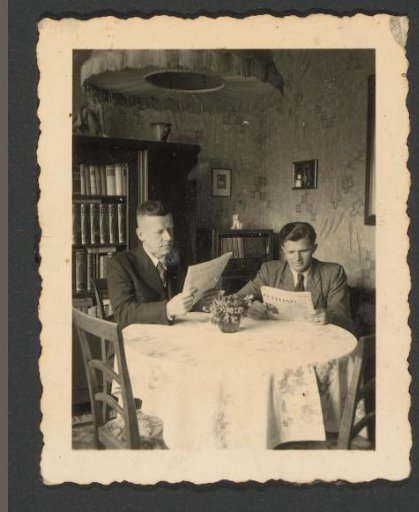 Two Men Reading at a Table