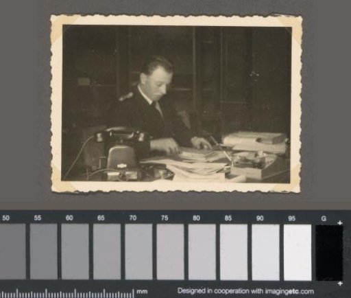 Ob. Wm. Meyer behind a desk