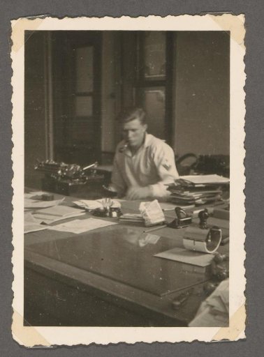 Soldier behind a desk with a typewriter