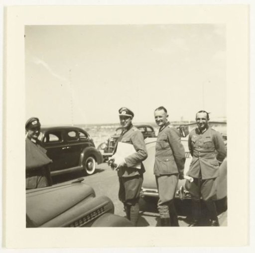 Four German soldiers with cars