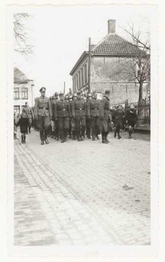 Wehrmacht soldiers walking in a street