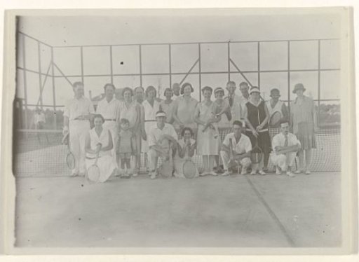 Company on a tennis court in Moengo