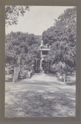 Woman standing before a house