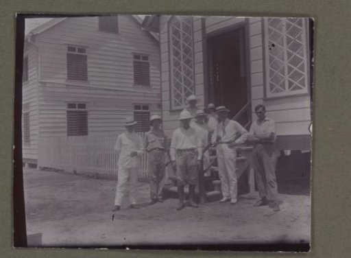 Group of men in front of a house