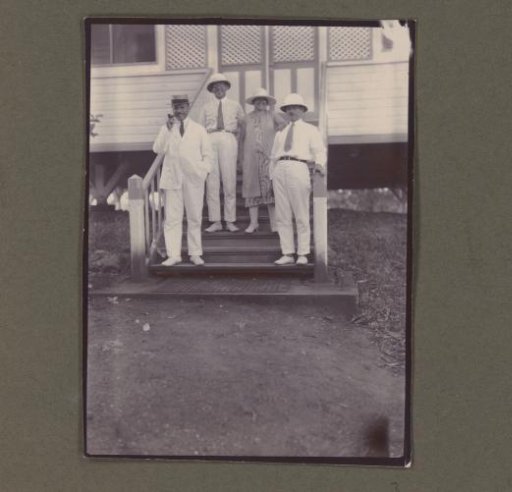 Photograph of three men and a woman
