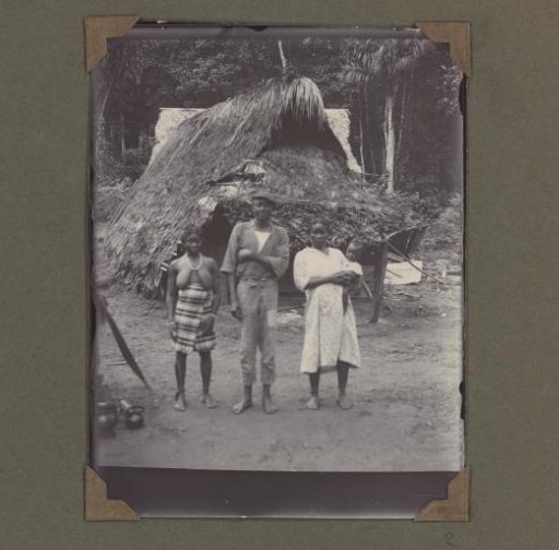 Villagers standing in front of a hut