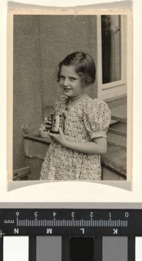 Isabel Wachenheimer in a polka-dot dress holding a cup, July 1936