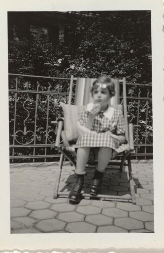 Isabel Wachenheimer eating a peach on a sun lounger on a terrace in Engelberg, August 1935