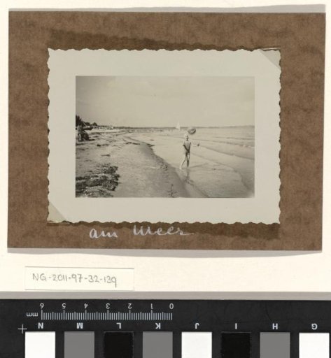 Isabel Wachenheimer on the beach by the sea, throwing a ball