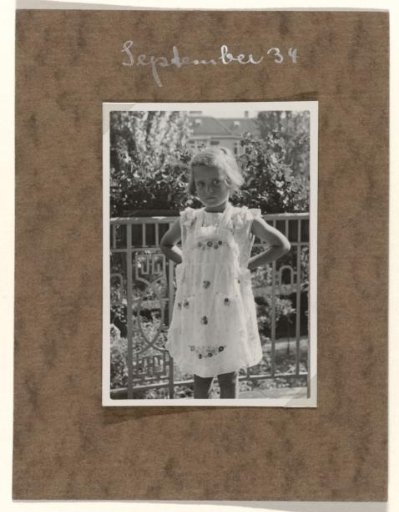 Isabel Wachenheimer in a Dress Before a Fence