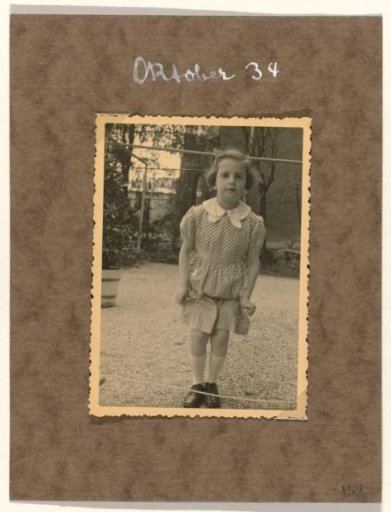 Isabel Wachenheimer in a Striped Dress Before a Row of Houses