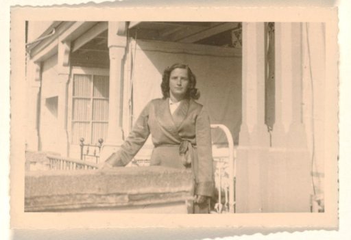 Isabel Wachenheimer in a dressing gown standing in front of the entrance to an open-air hospital ward in the Jewish sanatorium Etania in Davos, April 1946