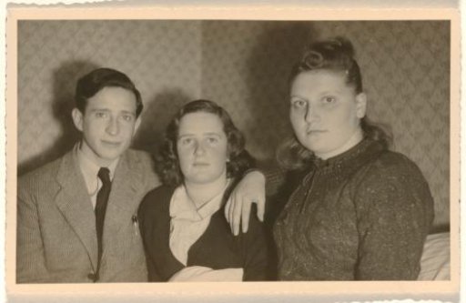 Leo Blumensohn in a striped jacket, Isabel Wachenheimer, and an unknown woman in front of diamond-patterned wallpaper, 1945