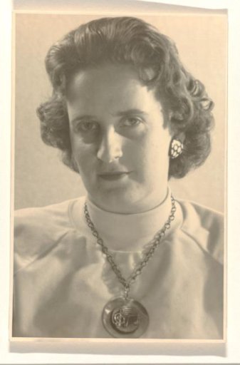 Isabel Wachenheimer with a turtleneck and a necklace with musical notes around her neck, looking to the left