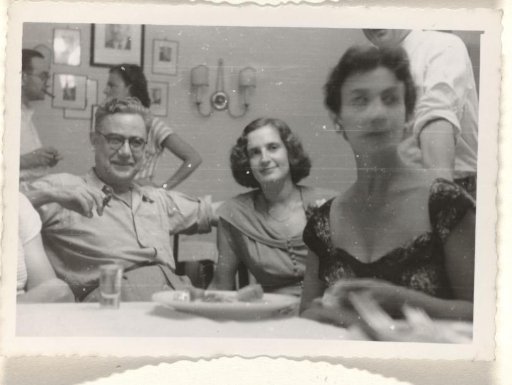 Isabel Wachenheimer with an unknown man and an unknown woman during a banquet for the poor