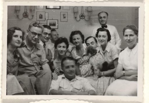 Isabel Wachenheimer with unknown people during a banquet for the poor