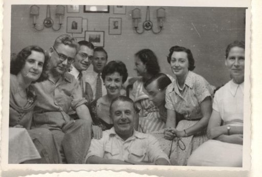 Isabel Wachenheimer with unknown people during a banquet for the poor