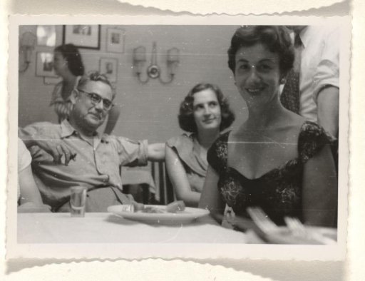 Isabel Wachenheimer with an unknown man and an unknown woman during a banquet for the poor