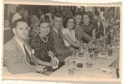 Isabel Wachenheimer seated at a table with bottles and glasses during a festive occasion with KLM colleagues