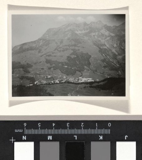 Mountain landscape with a village at the foot of the mountain, and vegetation on the mountain ridge