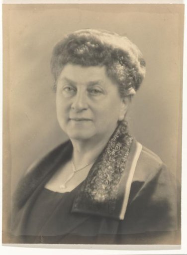 Portrait of Josefine Moos-Levi, with a pendant around her neck and an ornate fur collar on her dark clothing