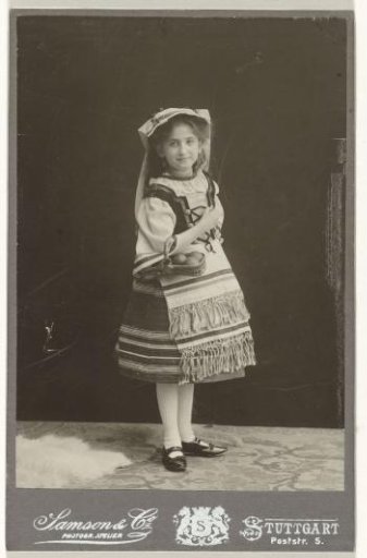 Else Wachenheimer-Moos as a young girl in South German folk costume, holding a filled basket in her arms