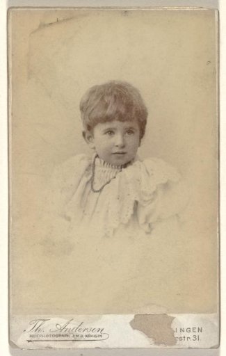 Young child, presumably Else Wachenheimer-Moos, in a child's dress with short hair and a necklace