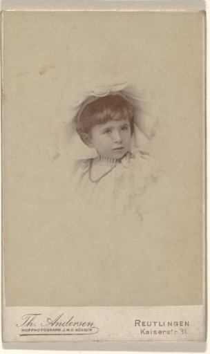 Young child, presumably Else Wachenheimer-Moos, in a child's dress with short hair, a head covering and a necklace