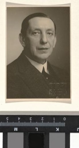Portrait of an unknown uncle dressed in a dark suit with a striped collar