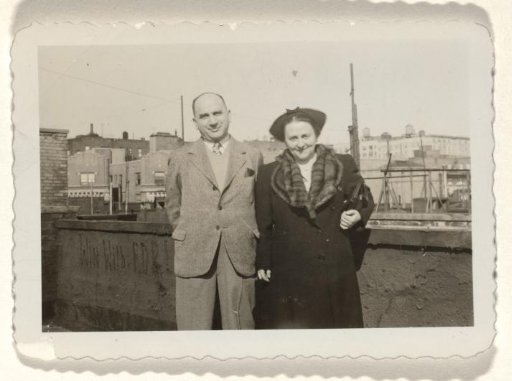 Uncle Julius and Aunt Rosel, Standing in Front of a Stone Wall with the Text "Win with FDR!" Written on It