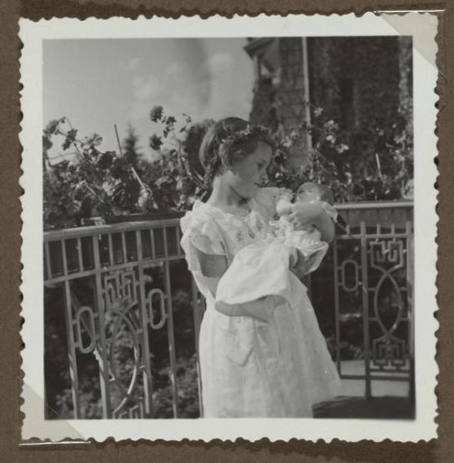 Isabel Wachenheimer on Her Birthday Holding a Doll on a Balcony