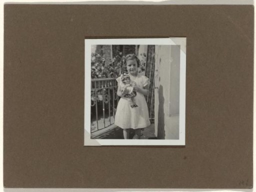 Isabel Wachenheimer on Her Birthday Holding a Doll on a Balcony