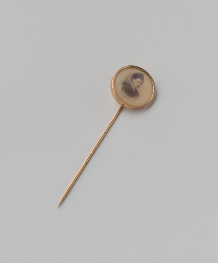 Photograph of a lady, set in a round holder attached to a pin