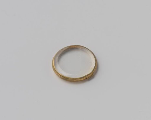 Round piece of glass, set in a metal ring