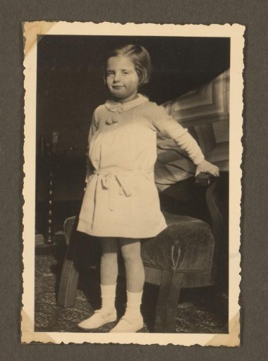 Isabel Wachenheimer standing before a chair in the Wachenheimer family home