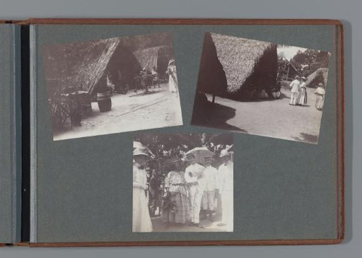 Huts and their Surinamese inhabitants; on the right, a Western-dressed woman is just visible