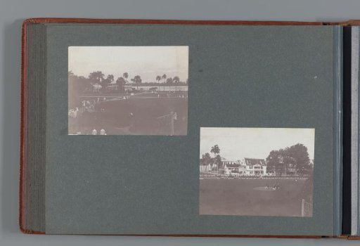 Dignitaries crossing a field bordered by soldiers standing at attention; in the background houses and palm trees