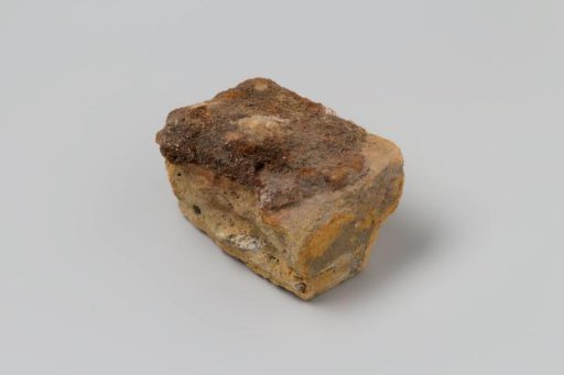 Part of a Brick with Concretion from the Wreck of the East Indiaman 't Vliegend Hart