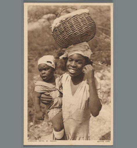 Portrait of a young woman holding a toddler and carrying a basket in Curaçao