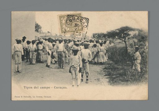 Large group of young people on and beside an unpaved road in Curaçao