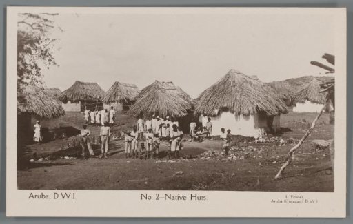 Portrait of a group of inhabitants of Aruba in front of their houses