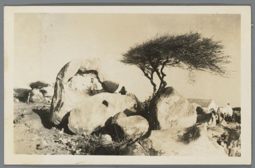 Portrait of Two People by a Rock Formation and a Dividivi Tree in Curaçao