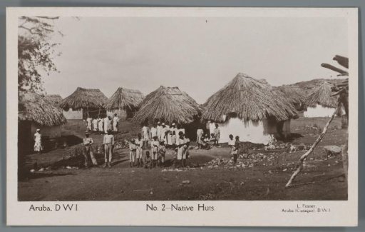 Portrait of a group of inhabitants of Aruba in front of their houses