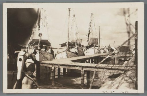 View of boats and wooden pier in the harbor on Aruba