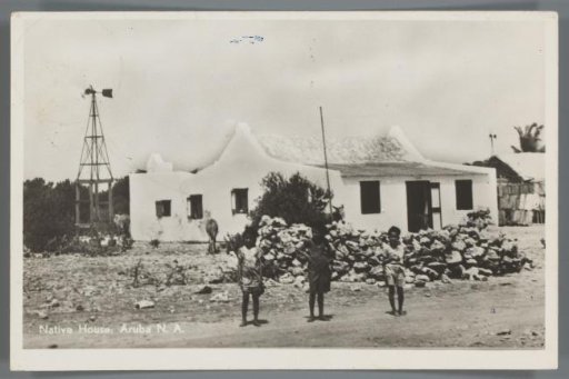 Three children with a house in the background